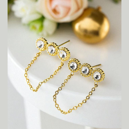 Boucles d'oreilles dorées triple strass avec chaîne