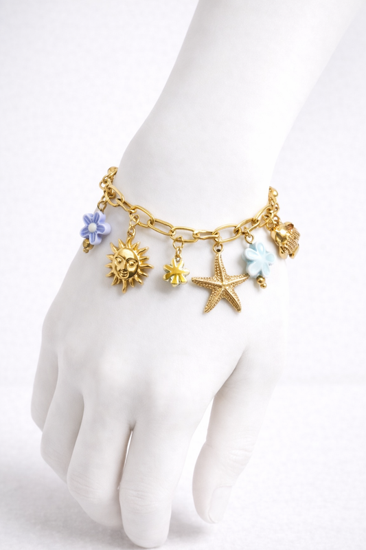 Bracelet chaîne dorée breloques de la mer fleurs bleues